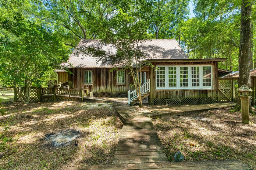 Hidden beneath towering hardwoods on a private wooded setting - photo 38