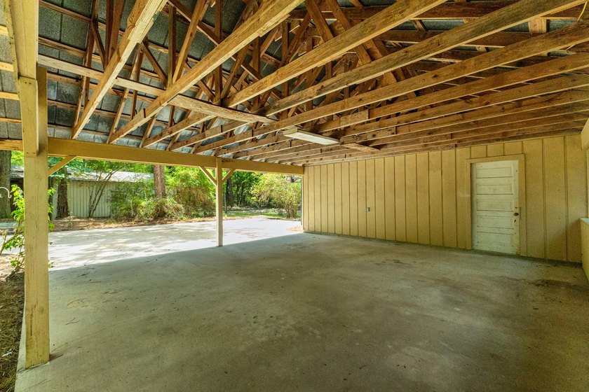 Hidden beneath towering hardwoods on a private wooded setting - photo 42