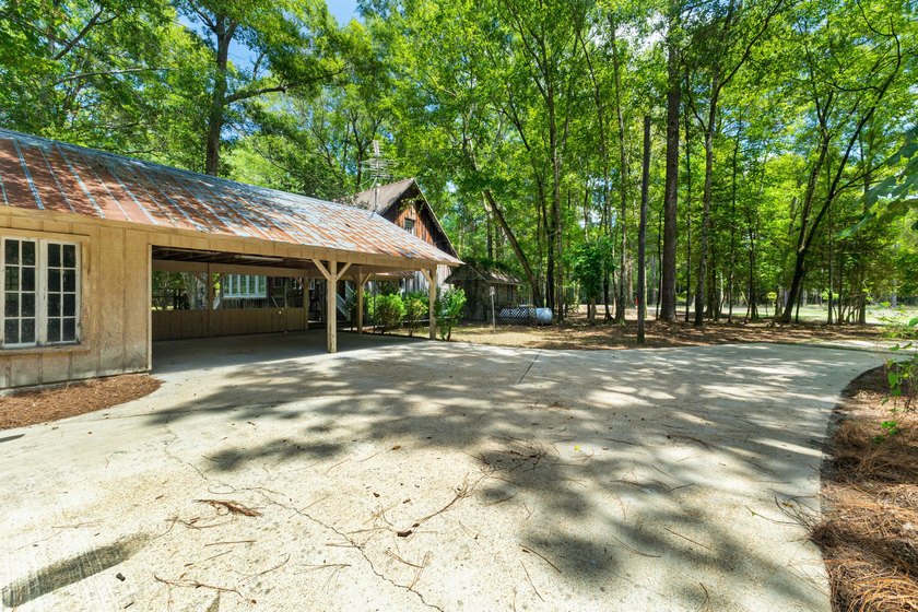 Hidden beneath towering hardwoods on a private wooded setting - photo 43