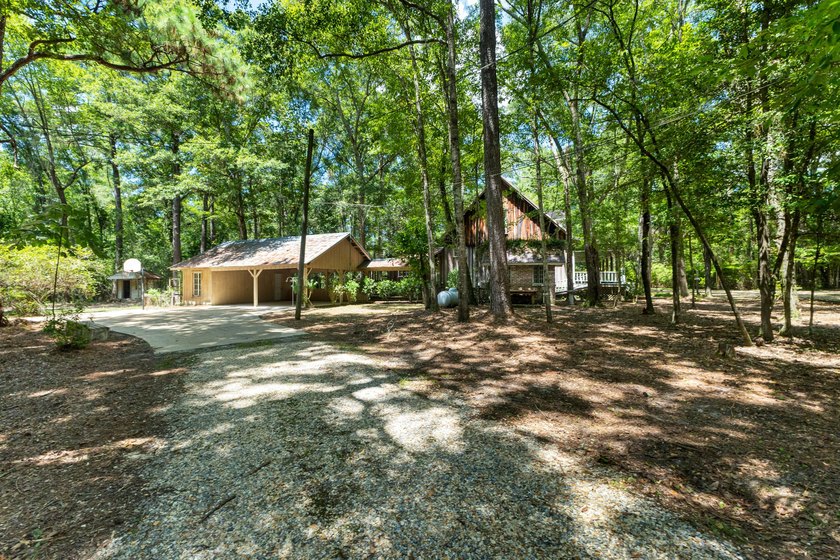 Hidden beneath towering hardwoods on a private wooded setting - photo 45
