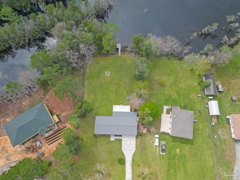 Set along 99 feet of watererfront, this updated brick home - photo 3