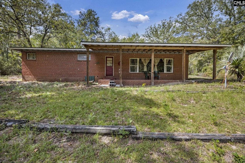 A long, private, tree-lined drive leads to a brick cabin - photo 11