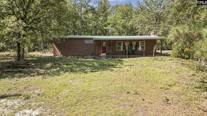 A long, private, tree-lined drive leads to a brick cabin - photo 12
