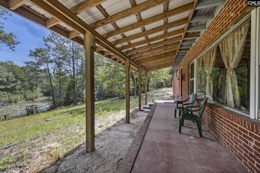 A long, private, tree-lined drive leads to a brick cabin - photo 15