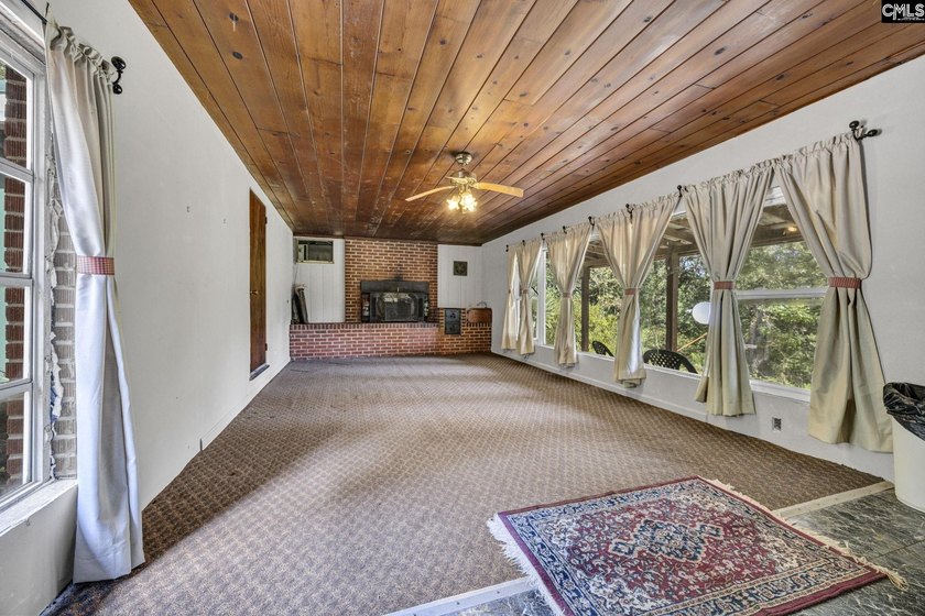 A long, private, tree-lined drive leads to a brick cabin - photo 16