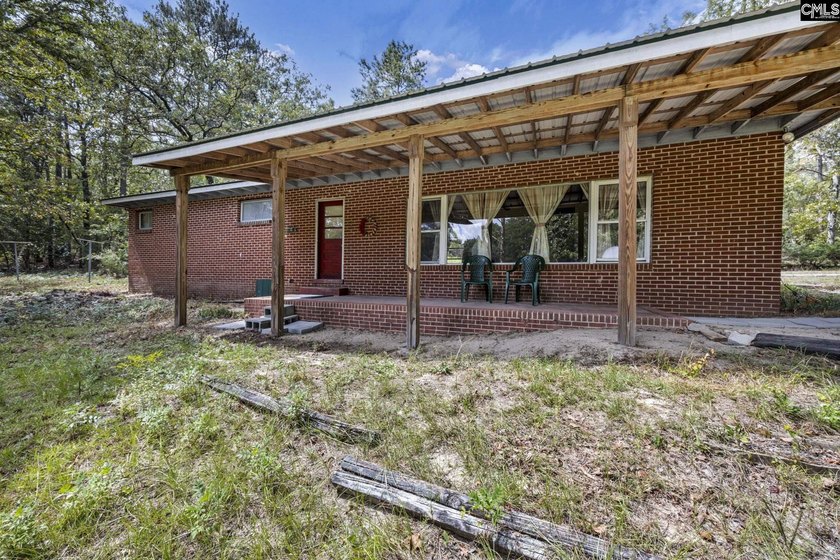 A long, private, tree-lined drive leads to a brick cabin - photo 26