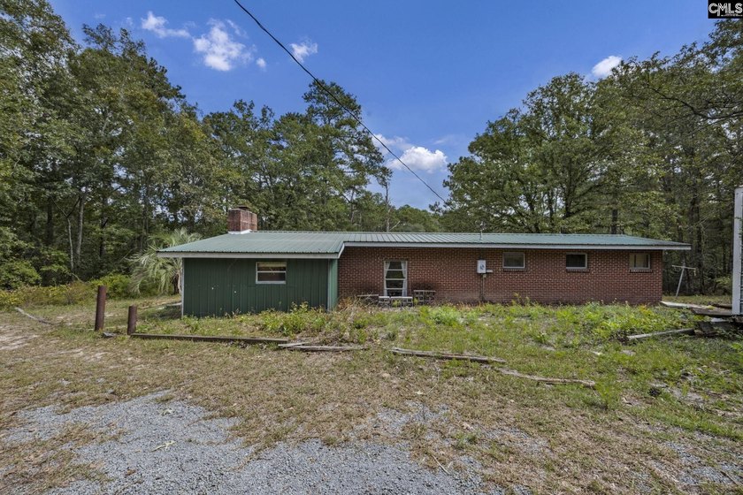 A long, private, tree-lined drive leads to a brick cabin - photo 29
