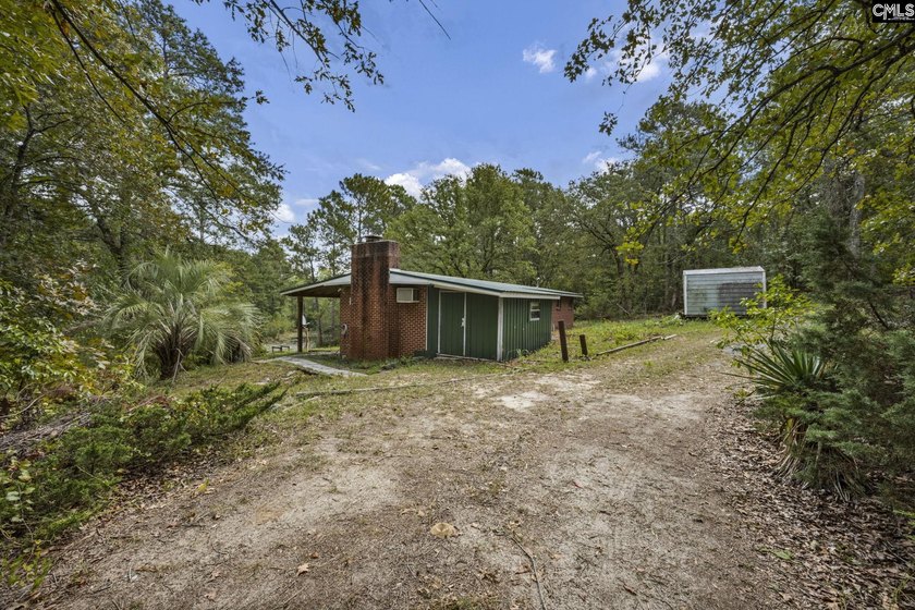 A long, private, tree-lined drive leads to a brick cabin - photo 30
