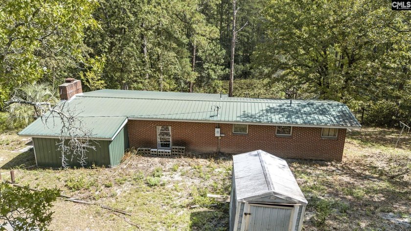 A long, private, tree-lined drive leads to a brick cabin - photo 31