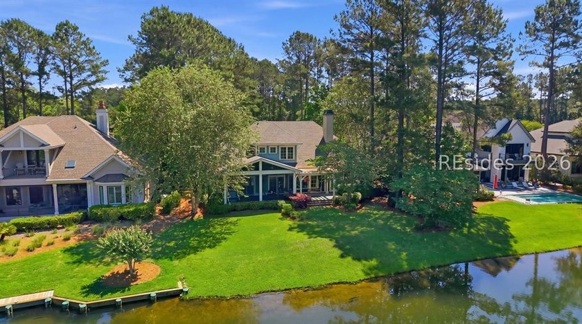Tucked into a serene waterfront setting where towering trees - photo 48