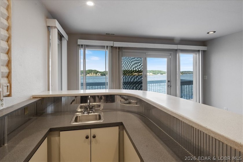 Perched above the shimmering waters of the Lake of the Ozarks - photo 38