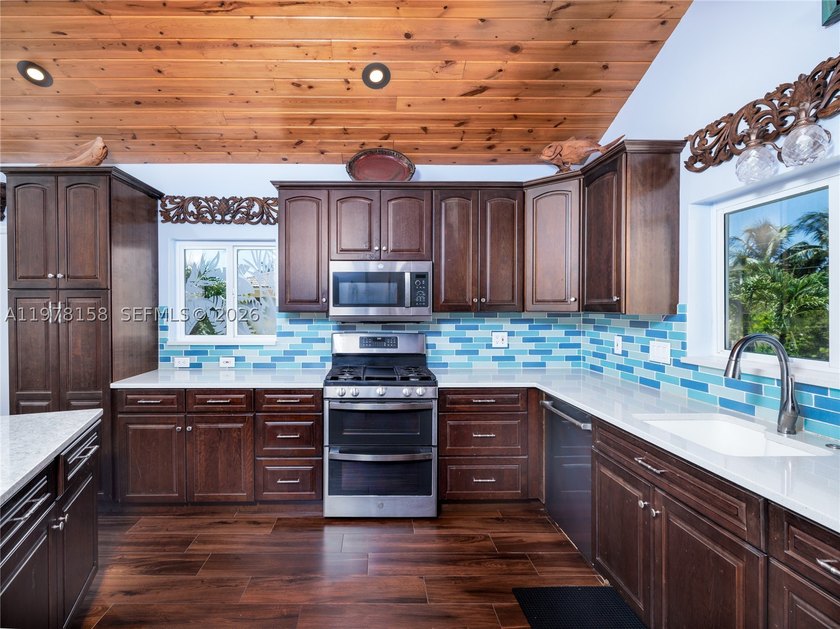 A rare waterfront estate along a 200-foot wide canal with a - photo 11