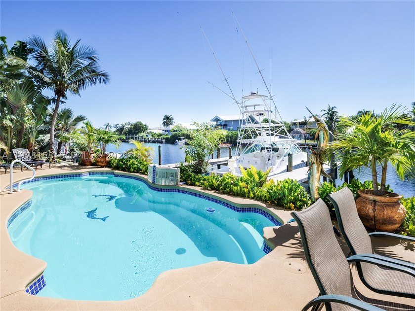 A rare waterfront estate along a 200-foot wide canal with a - photo 14
