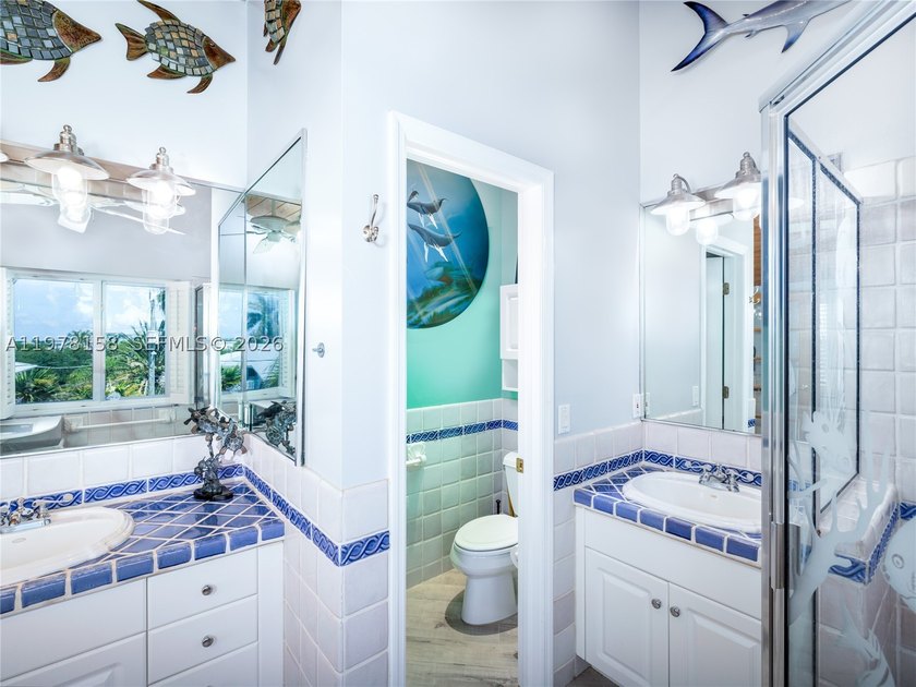 A rare waterfront estate along a 200-foot wide canal with a - photo 23