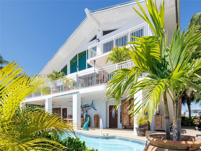 A rare waterfront estate along a 200-foot wide canal with a - photo 28