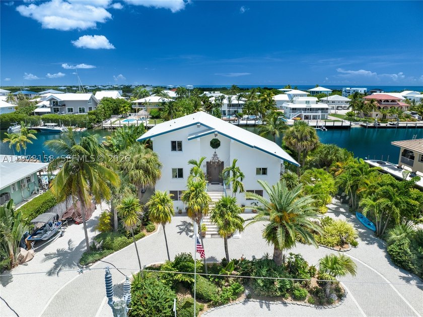 A rare waterfront estate along a 200-foot wide canal with a - photo 30