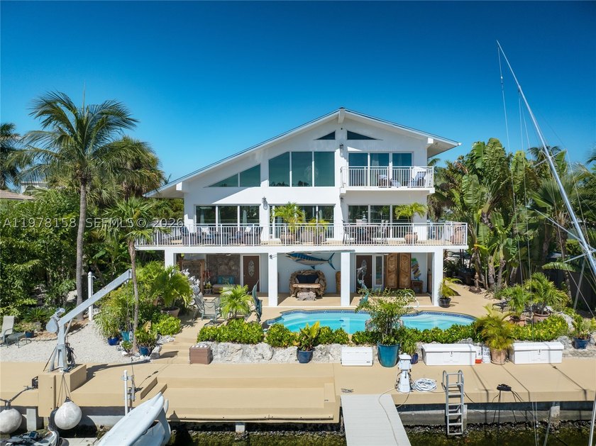 A rare waterfront estate along a 200-foot wide canal with a - photo 43