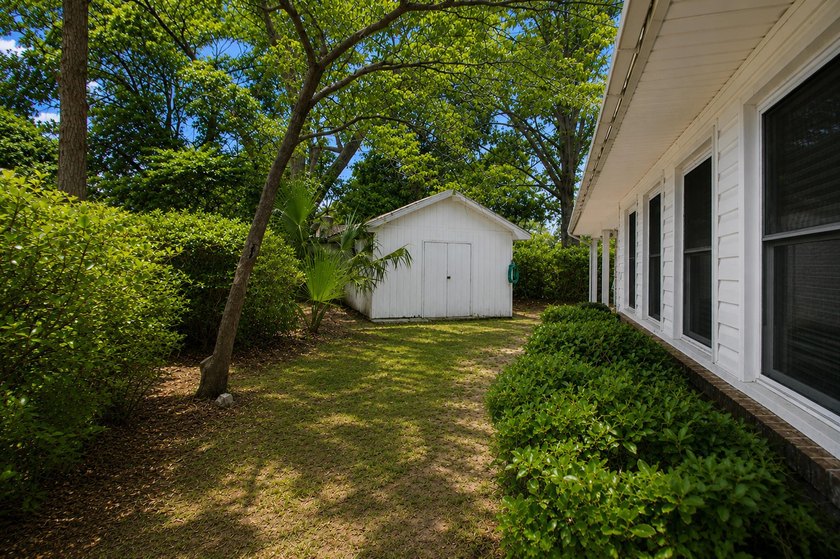 Situated on a spacious corner lot surrounded by mature trees - photo 23