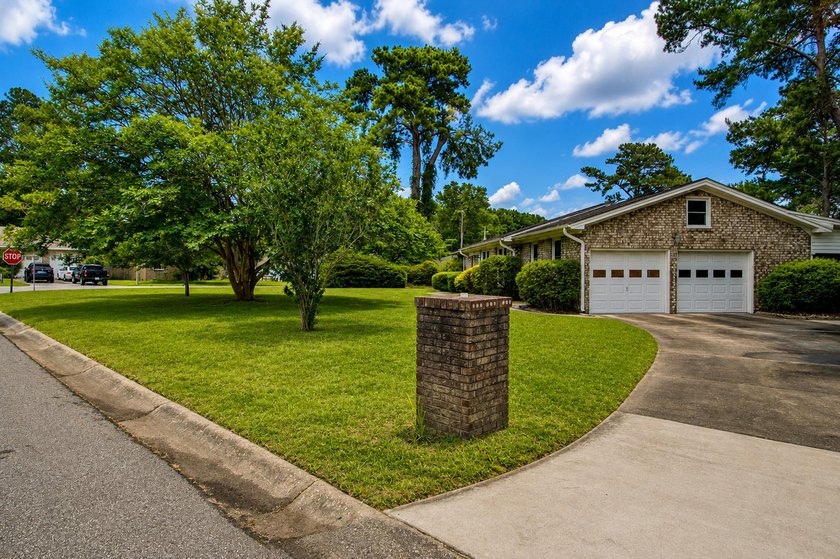 Situated on a spacious corner lot surrounded by mature trees - photo 34