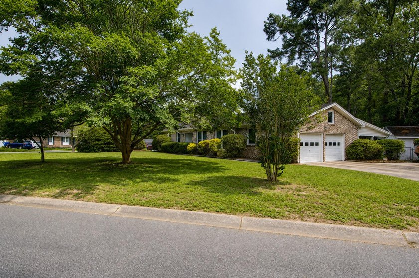 Situated on a spacious corner lot surrounded by mature trees - photo 35
