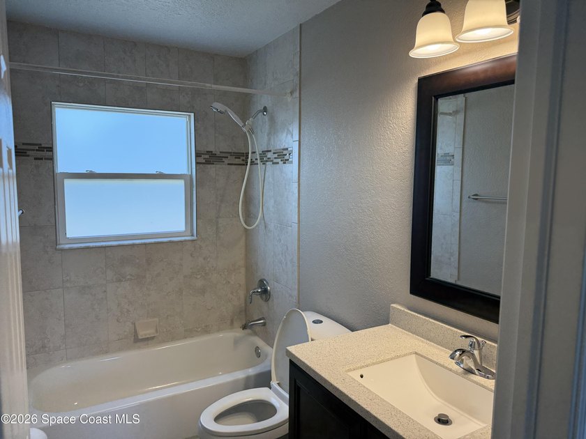 Step inside to find tile flooring flowing throughout the main - photo 9