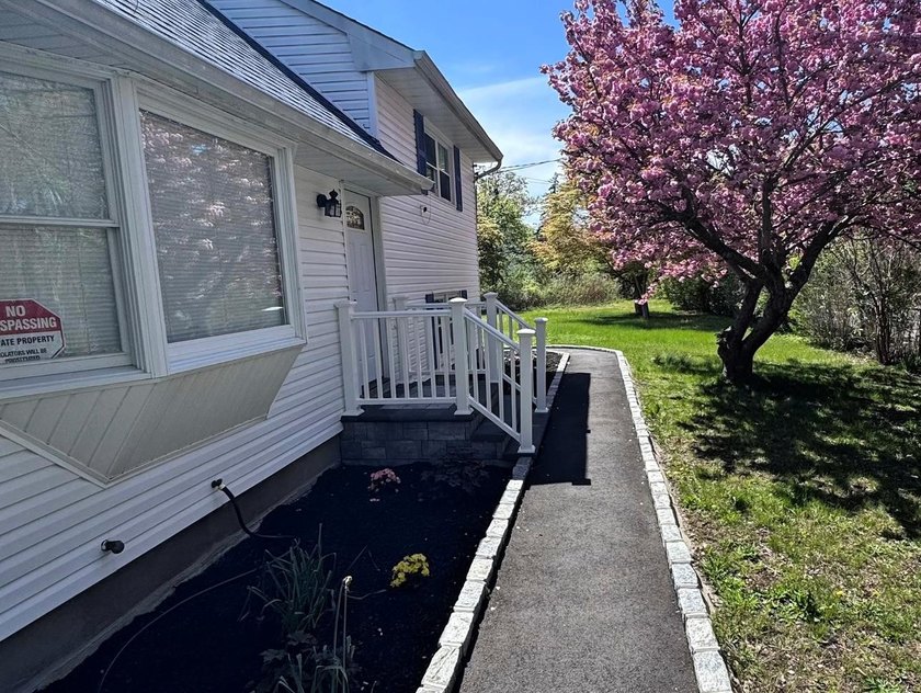 ISLIP School District. This split-level Newly Renovated Home has - photo 2