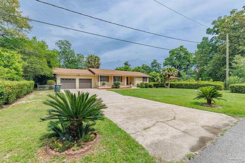 Welcome home to 902 N 75th Avenue, a charming property that - photo 3