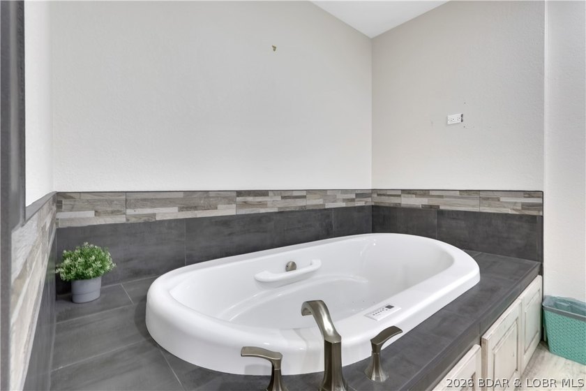 This 3-bedroom, 2-bath home on Nonsuch in Lake Ozark is now - photo 21