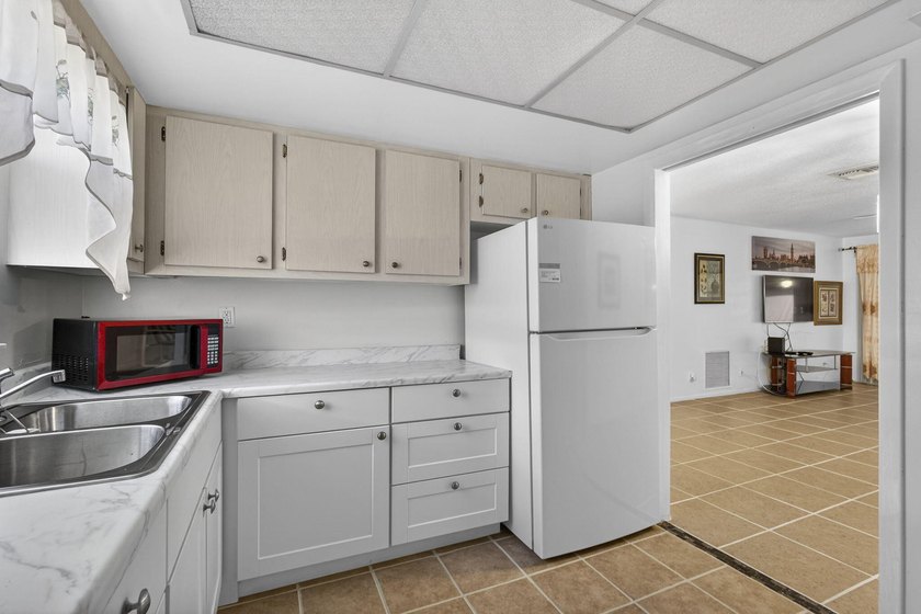 Welcome home to this inviting residence featuring tile floors &amp; - photo 17