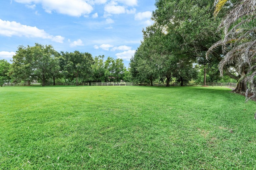 Situated on nearly 2 acres in the gated golf and equestrian - photo 34