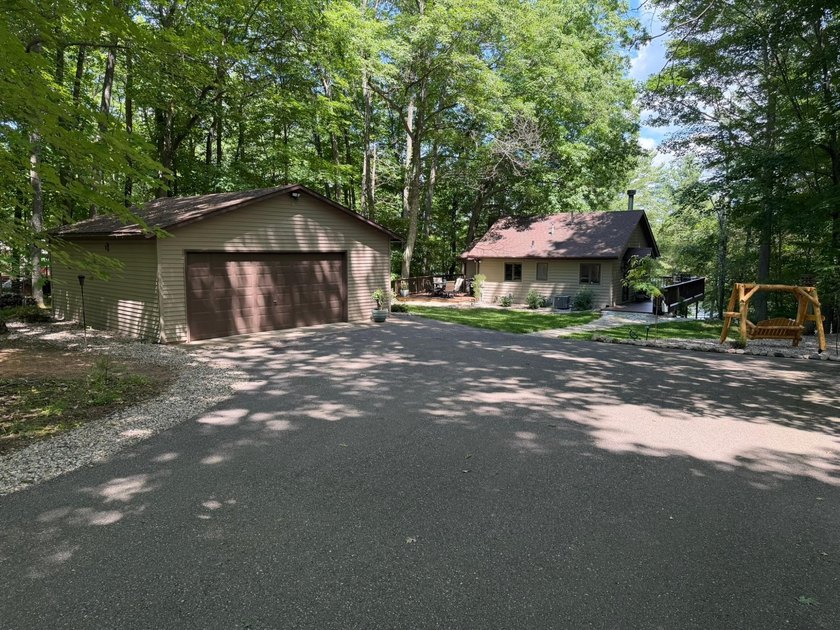 BIRD LAKE CHARMER. Tucked in the woods, this year-round home - photo 29