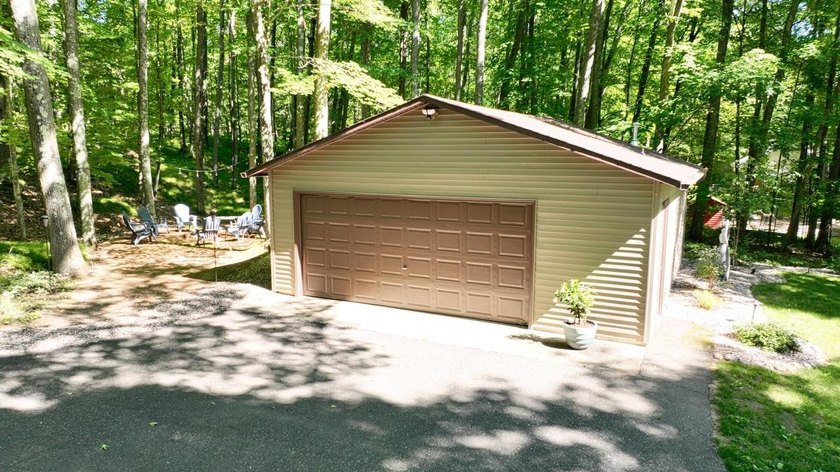 BIRD LAKE CHARMER. Tucked in the woods, this year-round home - photo 33