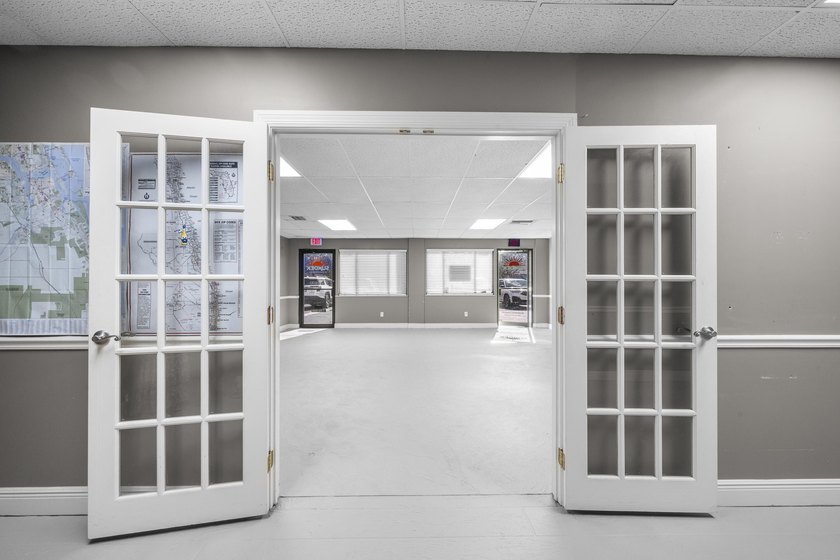 Bright, open showroom with newly applied SunDek finished floors - photo 11
