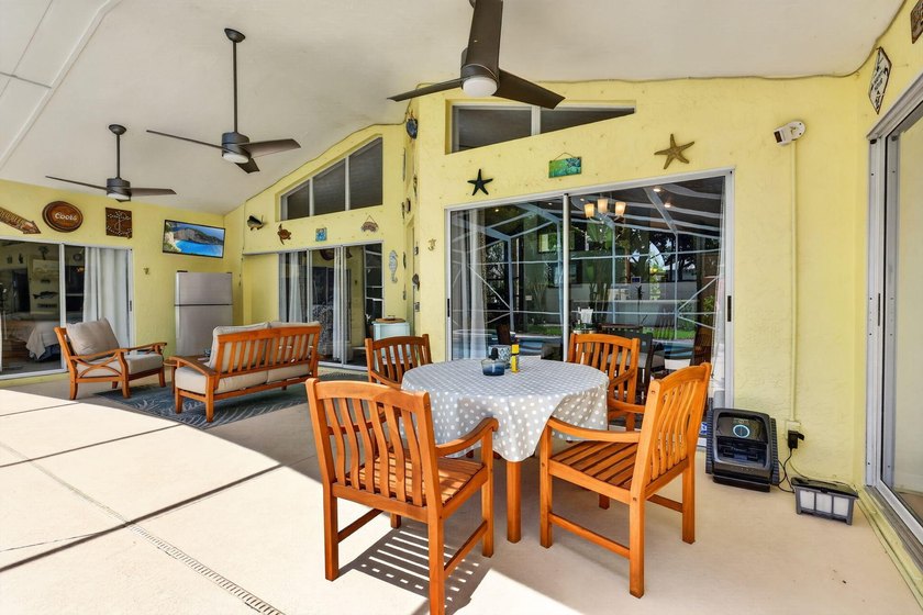 Palm trees sway over your private, screened pool at this move-in - photo 31