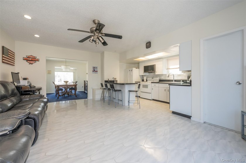 Deceptive from the outside, this expanded Colonial home offers - photo 2