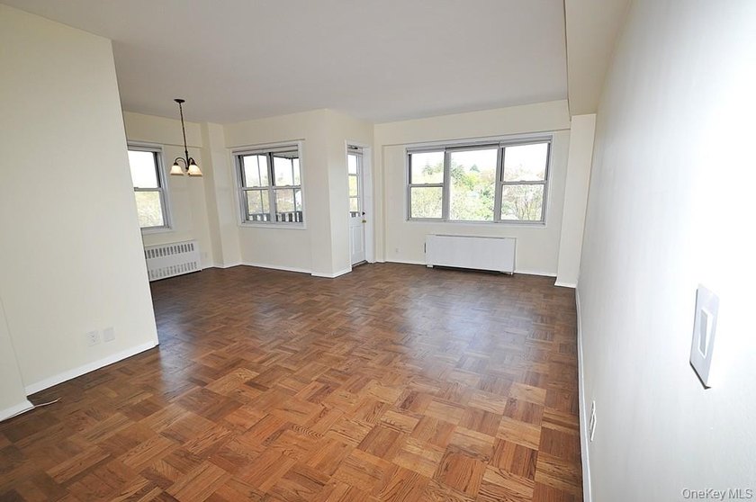 Perched on the top-floor corner, this sun-drenched 2-bedroom - photo 8