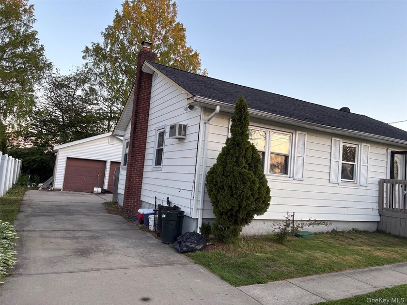 The home features a large driveway, a two-car garage, stainless - photo 12