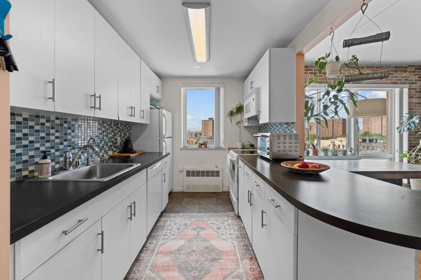 Welcome to 853 Macy Place #8E, a rare top-floor, corner - photo 4
