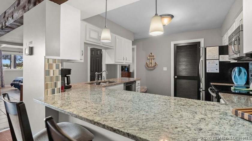 Turnkey Lakefront Living with a Dock Slip Included! Discover - photo 8