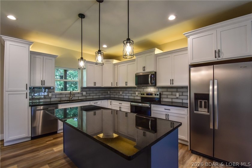 BRAND NEW HOME in the HEART of Osage Beach!! This striking home - photo 5