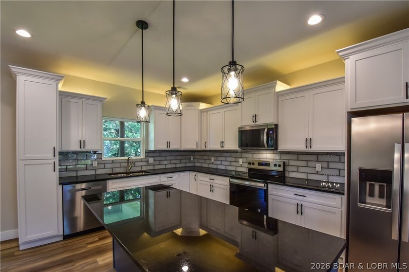 BRAND NEW HOME in the HEART of Osage Beach!! This striking home - photo 6