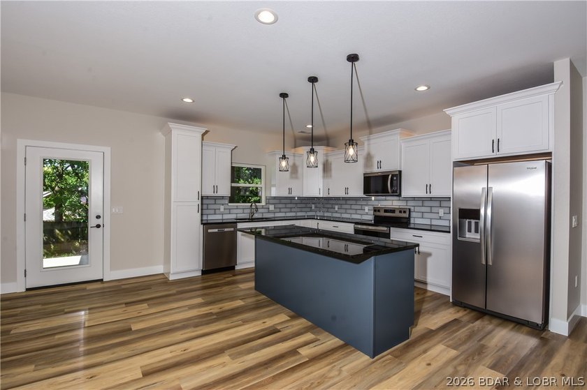 BRAND NEW HOME in the HEART of Osage Beach!! This striking home - photo 7
