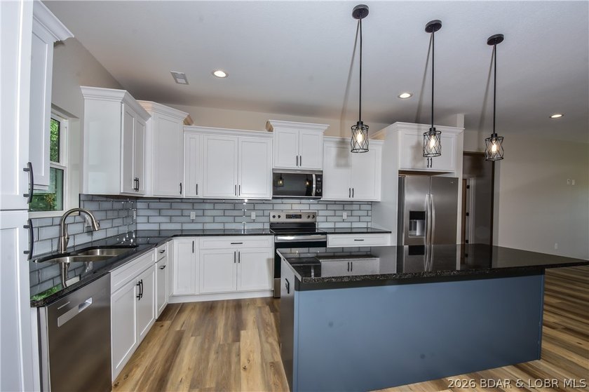 BRAND NEW HOME in the HEART of Osage Beach!! This striking home - photo 9