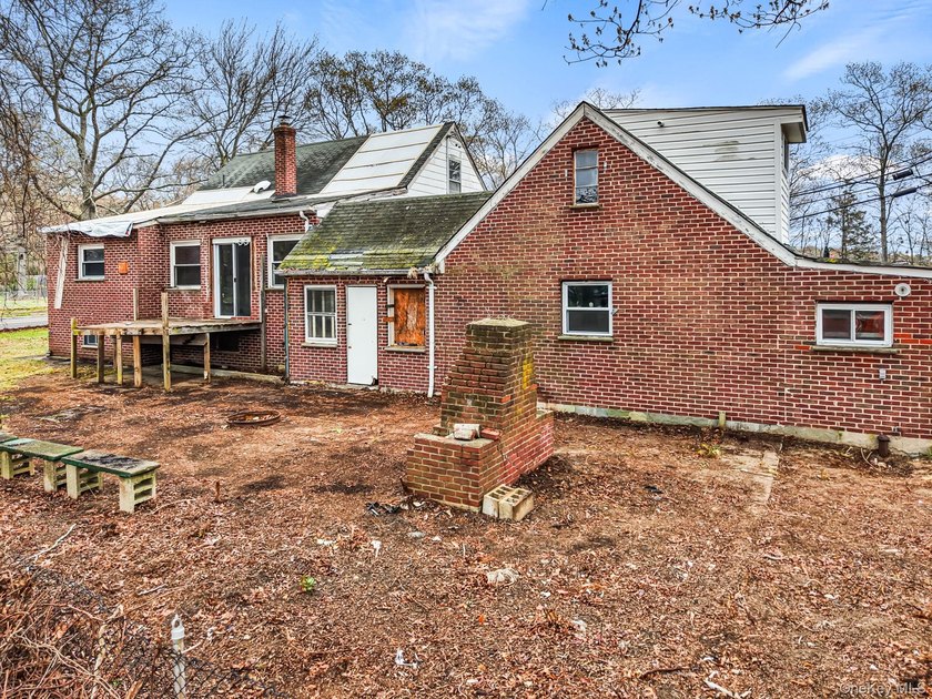 This spacious corner property nestled on a estimated half-acre - photo 6