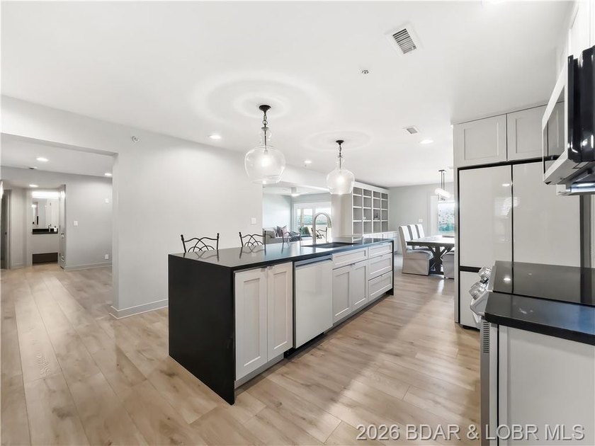 Turnkey luxury and breathtaking lakefront views await in this - photo 4
