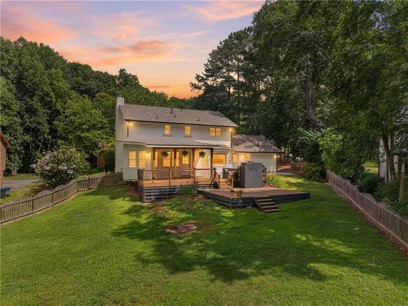 Tucked into a private wooded lot with a stunning lake view in - photo 3
