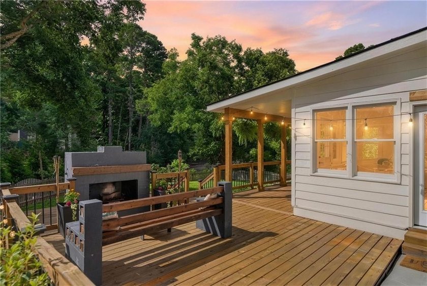 Tucked into a private wooded lot with a stunning lake view in - photo 4
