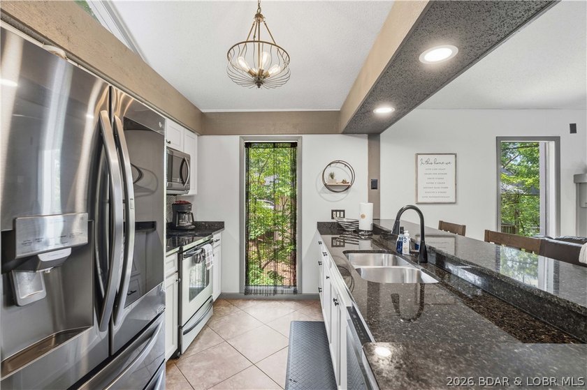 Tucked among the trees in the sought-after Tan-Tar-A Estates - photo 8