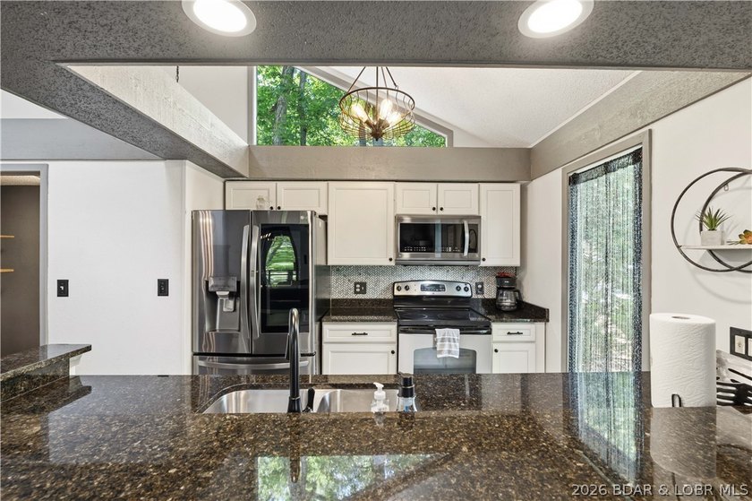 Tucked among the trees in the sought-after Tan-Tar-A Estates - photo 9
