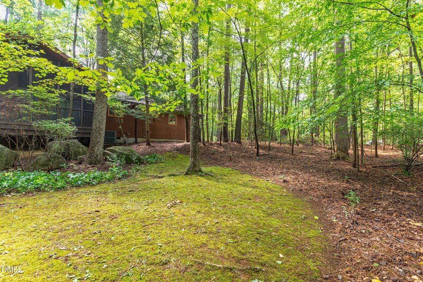Tucked away on a sprawling corner lot of over 1/2 an acre in the - photo 22